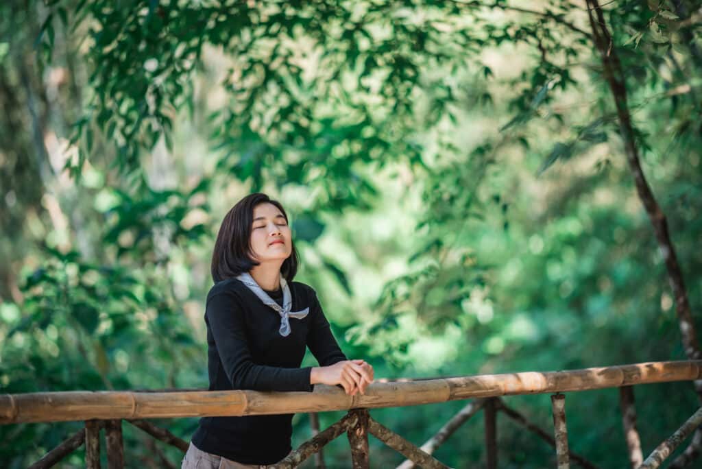 young woman relaxing in forest