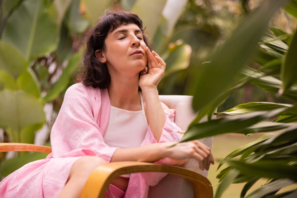 woman sitting beside plants